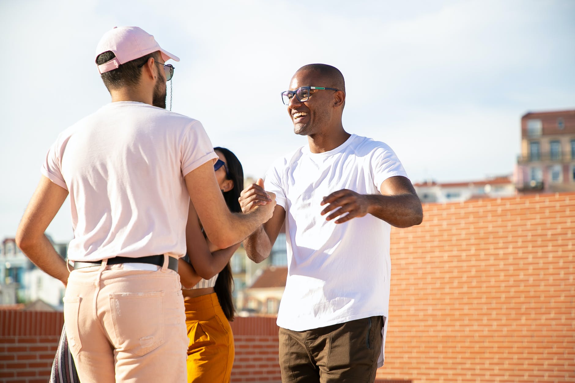 Image of two Black males greeting each other.