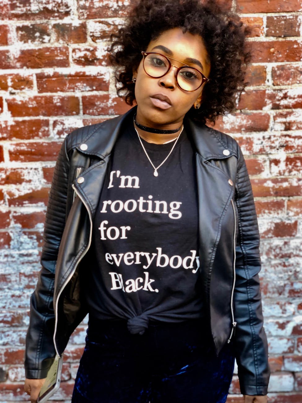 Image is of a Black person wearing a tee shirt that says "I'm rooting for everybody Black"